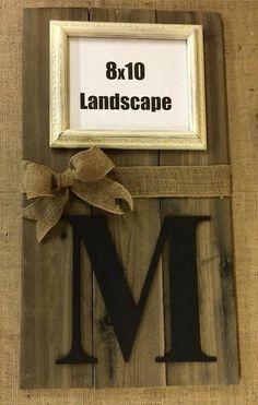 a wooden sign that says 8x10 landscape with a bow on the letter m