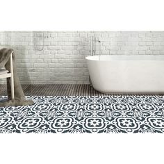 a bath tub sitting next to a wooden chair on top of a tile covered floor