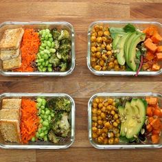 four plastic containers filled with assorted vegetables and meats on top of a wooden table