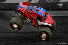 a red monster truck is in the air