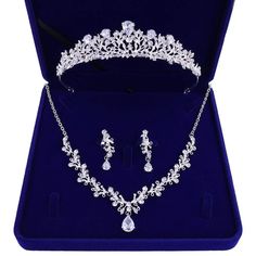 a tiara and earring set in a blue velvet box with matching necklace and earrings