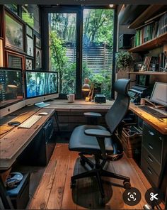 a computer desk sitting in front of a window filled with lots of books and pictures