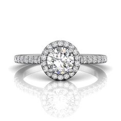 a white gold engagement ring with an oval diamond center surrounded by pave set diamonds