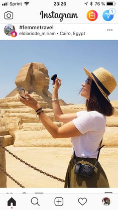 a woman taking a selfie in front of an egyptian sphinx