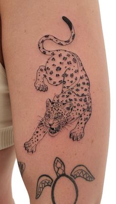 a woman with a tattoo on her arm and the image of a cheetah