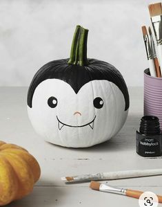 a painted pumpkin sitting on top of a table