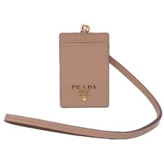 This stylish Prada badge holder is perfect for everyday use. Whether you're a working woman or a student, with this badge holder, you'll always be close to your necessary ID. The swivel hardware combined with the Prada logo featured prominently on the beige leather back allows for discrete concealment of any personal information. This badge holder functions with or without the lanyard.     Model: 1MC007  Beige Vitello Move Textured Leather  Gold Tone Hardware  Swivel Hardware  Metal Prada Logo Everyday Wallets With Logo Plaque, Leather Card Holder With Logo Plaque For Everyday, Cardholder Wallet, Versus Versace, Prada Logo, Bracelets Gold Diamond, Gold Diamond Earrings, Casual Watches, Working Woman