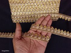 a hand is holding some gold sequins