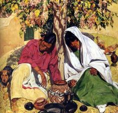 two women sitting next to each other under a tree with dogs on the ground near by