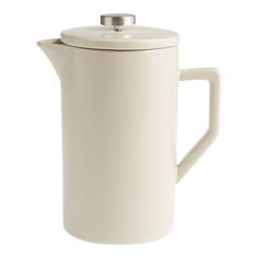 a white tea pot with a lid and handle is shown on a white background, it appears to be empty