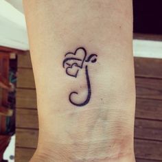 a small tattoo on the ankle of a woman's foot, with an umbrella