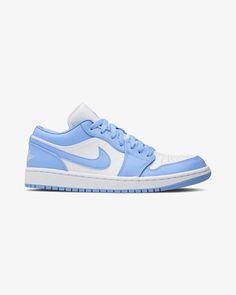 The women's Jordan 1 Low UNC (W) features a white and blue leather upper with standard white acting as the base of the silhouette and wrapped up in the pale tones of the University Blue overlays. From there, blue on the "Jumpman" logo tongue, laces, and Nike "Swoosh" and a University Blue outsole complete the design. Jordan Lows, Jordan 1 Low Unc, Sneaker Displays, Jordan Mid, Nike X Travis Scott, Jordan Low, All Nike Shoes, Jumpman Logo, Womens Jordans