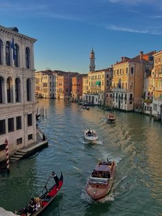 two boats are traveling down the canal in venice