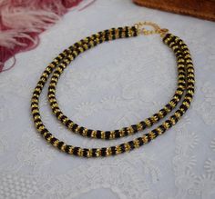 These stunning German beads are made of faceted jet glass with gold engraving on the ends. They are full of visual interest and catch and reflect the light beautifully! The first strand is 16" long and the second strand is 19" long and there is a 3" extension chain. Appropriate for Regency thru Victorian use See more Black jewelry here: https://www.damesalamode.com/search?type=product&q=black Gold Multi-strand Necklace With Black Beads, Gold Double Strand Necklaces With Spacer Beads, Gold Necklaces With Black Beads Long Shape, Gold Engraving, Black Jewelry, Cross Pendant Necklace, Silk Ribbon, Black And Gold, Cross Pendant