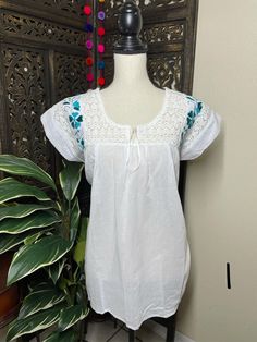 Precious Embroidered Blouse made in Puebla, Mexico by our Mexican partners. Super light weight and fresh looking. The embroidered design is beautiful and delicate. All the work is clean, and with a professional finish and hand embroidered. You will look gorgeous for a friends night out or a summer cookout day, your call. You will Love it either way.... :) Blouse STYLE DETAIL Overview * soft cotton fabric * round-neck * hand embroidered design * short sleeves fit & sizing MEDIUM fabric & Fitted Embroidered Short Sleeve Top, Fitted Embroidered Top With Short Sleeves, Fitted Short Sleeve Embroidered Top, Fitted Short Sleeve Top With Embroidered Hem, Fitted Casual Embroidered Top With Intricate Embroidery, Casual Fitted Embroidered Top With Intricate Embroidery, Fitted Casual Top With Intricate Embroidery, Casual Fitted Blouse With Intricate Embroidery, Fitted White Embroidered Top With Embroidered Hem