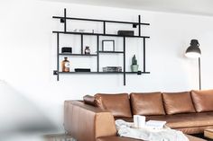 a brown leather couch sitting in front of a wooden table