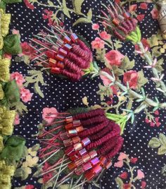 several different types of flowers are arranged on a tablecloth with polka dots and floral designs