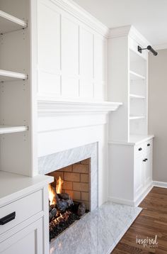 a fireplace with white cabinets and a fire place