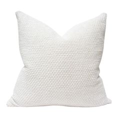 a white pillow with a textured design on the front and back, sitting on a white background