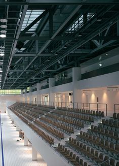 an empty stadium with rows of seats and lights on either side of the bleachers