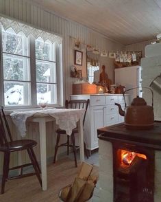 a stove top oven sitting inside of a kitchen next to a dining room table and chairs