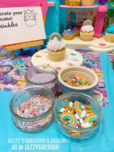 cupcakes and other treats are on display at a birthday party for children with rainbow theme