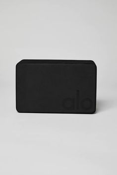 a black rectangular object with the letter o on it's front end, sitting against a white background