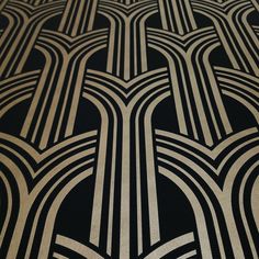 an art deco wallpaper pattern with black and white lines in the center, on a dark background