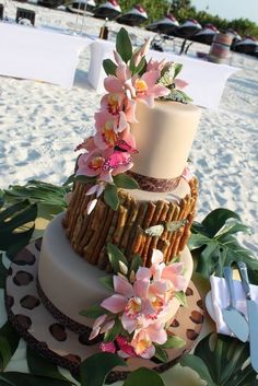 a three tiered cake with pink flowers on top