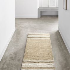 a white room with a rug on the floor