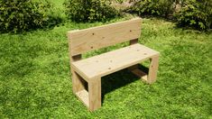 a wooden bench sitting on top of a green grass covered park field next to bushes