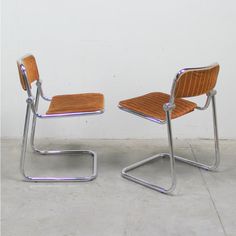 two chairs sitting next to each other on a cement floor