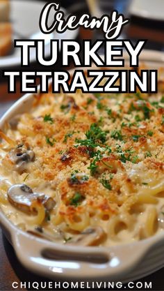 creamy turkey tetrazzini with mushrooms and parsley in a white casserole dish