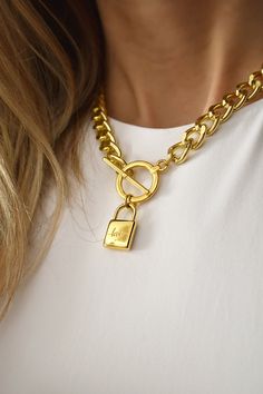 Gold Padlock Necklace, Chunky Chain Lock Necklace, Curb Chain with Lock Pendant, Short Statement Necklace, Chain Choker for Women A striking necklace that will level up your everyday style, for sure.  Featuring a chunky, yet lightweight curb link chain with a 24K gold plated toggle clasp and a padlock pendant, this is the absolute edgy classic piece of jewelry.  The padlock has the word "love" engraved on one side and is plain and shiny on the other side, meaning you can wear it any way you wish Metal Chain Link Necklace With Lock, Metal Jewelry With Lock, Metal Charm Necklaces With Chunky Chain For Gifts, Metal Charm Necklace With Chunky Chain For Gift, Gift Toggle Necklace With Chunky Chain, Gold Chain Link Necklace With Lock, Metal Chain Necklace With Lock For Gift, Gold Chain Link Toggle Necklace Gift, Gift Gold Chain Toggle Necklace