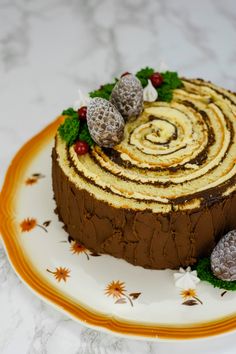 a chocolate cake with white frosting and raspberries on top, sitting on a plate