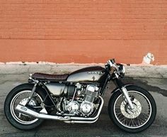 a motorcycle parked in front of a brick wall