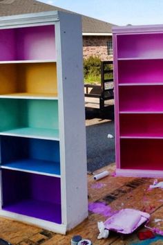 two bookshelves are being painted in different colors