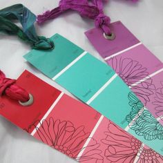 four different color swatches are laid out on a sheet of paper and tied together