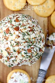 a cheese ball on a cutting board surrounded by crackers