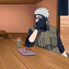 an anime character sitting at a table with food and drink in front of him on the phone