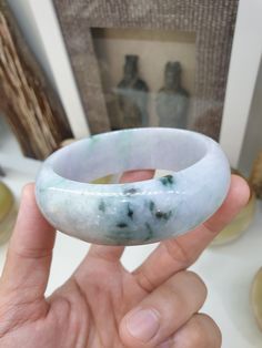 Wear a stare worthy piece of stone bangle 😃! Speckled green Lavender Jade bangle bracelet, high dome (0.95 cm thick), wide cut (2.3 cm width). A vintage piece from our old collection; manually cut and polished with lovely sheen and natural stone lines. Glossy, semitranslucent, Fei Cui, Type A natural Jadeite (non-bleached, non-dyed, non-treated material). Bangle size 65 (6.5 cm inner diameter), weighs 135 grams. Spiritual Green Bangle Cuff Bracelet, Handmade Green Round Cuff Bracelet, Jade Bangle Bracelet, Lavender Jade, Green Lavender, Stone Bangle, Jade Bangle, Type A, Bangle Bracelet