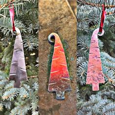 three different colored ornaments hanging from a tree