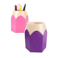 two pink and purple vases with pencils in them