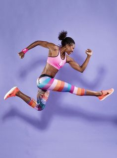 a woman jumping in the air wearing colorful socks