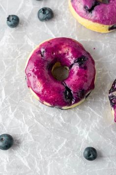 two donuts with blueberries are on a table