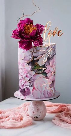 a cake decorated with flowers and the word love on top