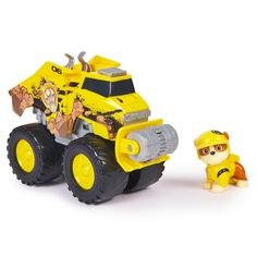 a yellow toy truck next to a small dog on a white surface with a white background