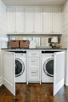 a washer and dryer in a white laundry room