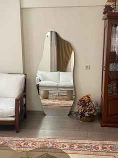 a living room filled with furniture and a large mirror