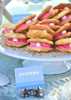 there are many cookies on the plate with pink frosting